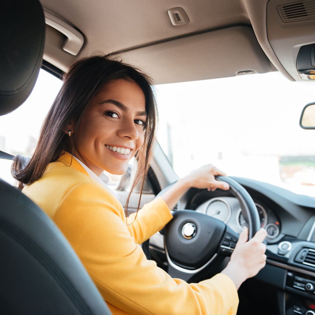 Smiling customer driving a Hassims hire car